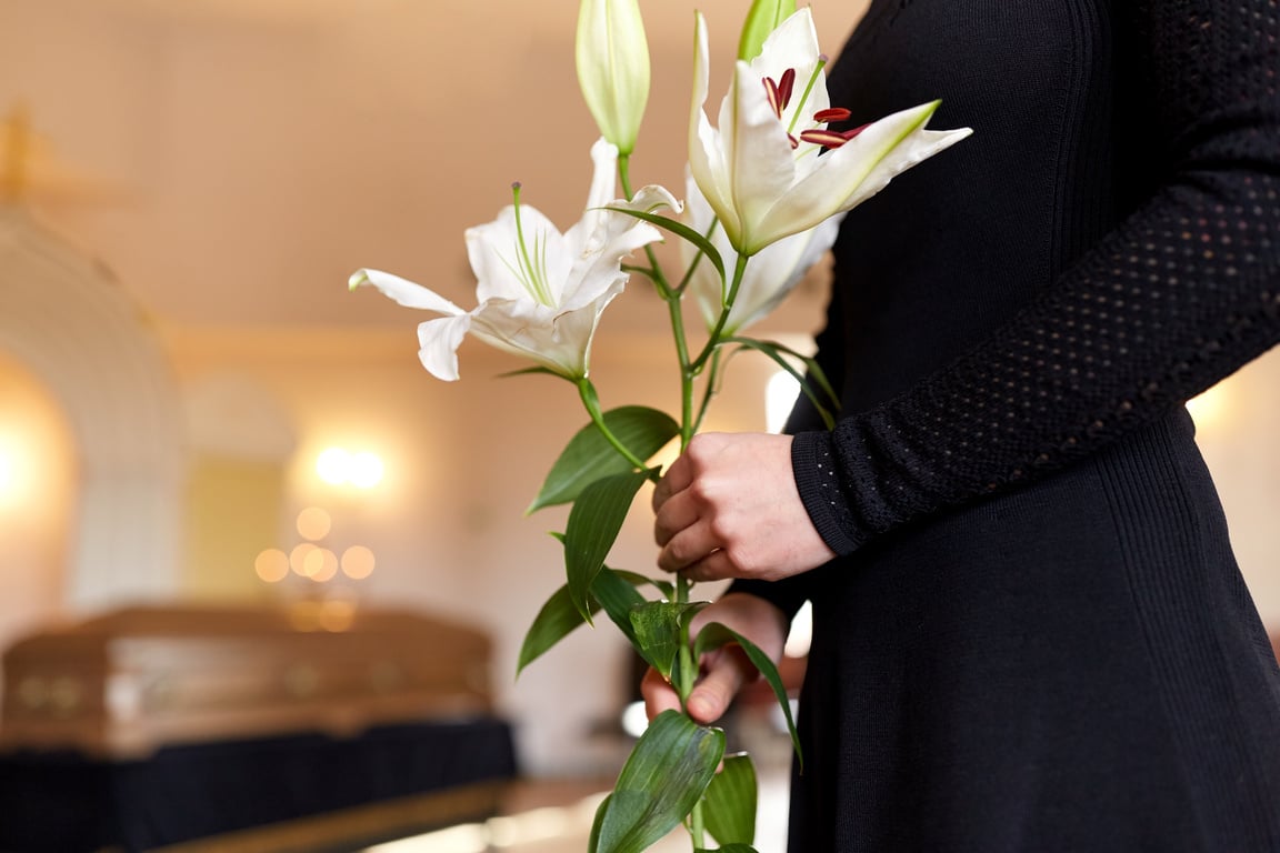 Woman with Lily Flowers at Funeral